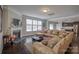 Open living room with fireplace, view into kitchen, and large sectional sofa at 3836 Lake Breeze Dr, Sherrills Ford, NC 28673