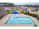 Community pool with a blue umbrella and surrounding homes at 3836 Lake Breeze Dr, Sherrills Ford, NC 28673