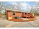 Brick home featuring a wooden deck and a patio area at 407 Thomas St, Marshville, NC 28103