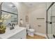 Well-lit bathroom featuring a glass door shower, white vanity, sleek fixtures, and a modern design at 407 Thomas St, Marshville, NC 28103