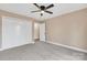 Spacious bedroom with plush carpet, a ceiling fan, a closet, and ample space for personalization at 407 Thomas St, Marshville, NC 28103