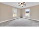 Bedroom featuring neutral walls, carpeted floors, two large windows, base molding, and a ceiling fan at 407 Thomas St, Marshville, NC 28103