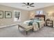 Cozy bedroom with a plush bed, stylish lamps, two windows, and a comfortable bench at 407 Thomas St, Marshville, NC 28103