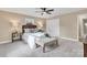 Charming bedroom with two lamps, a plush upholstered bench, neutral decor, and a large window at 407 Thomas St, Marshville, NC 28103