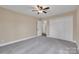 Bedroom with a ceiling fan, carpeted floor, access to a hall and a closet with white doors at 407 Thomas St, Marshville, NC 28103