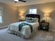 Comfortable bedroom with carpet, a queen-size bed, and bedside tables with lamps at 407 Thomas St, Marshville, NC 28103