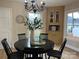 Dining room with a round black table and a chandelier, next to a storage cabinet at 407 Thomas St, Marshville, NC 28103