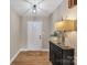 Inviting foyer with a modern light fixture, stylish table lamp, and hardwood floors at 407 Thomas St, Marshville, NC 28103