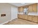 Functional laundry room with ample cabinet space, a sink, and wood-look flooring at 407 Thomas St, Marshville, NC 28103