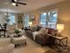 Cozy living room featuring hardwood floors, a ceiling fan, and large windows for natural light at 407 Thomas St, Marshville, NC 28103