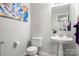 Stylish powder room with pedestal sink and decorative mirror at 4210 Saguaro Ct, Charlotte, NC 28269