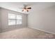 Spacious bedroom with ceiling fan and neutral carpeting at 4210 Saguaro Ct, Charlotte, NC 28269