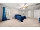 Spacious bedroom with plush carpeting and ceiling fan at 4210 Saguaro Ct, Charlotte, NC 28269