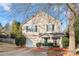 Two-story house with beige siding, green door, and attached garage at 4210 Saguaro Ct, Charlotte, NC 28269