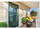 Front porch with green door, yellow pillows, and potted plants at 4210 Saguaro Ct, Charlotte, NC 28269