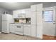 White kitchen with granite countertops and stainless steel appliances at 4210 Saguaro Ct, Charlotte, NC 28269