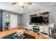 Living Room with gray walls, wood floors, and a modern entertainment center at 4210 Saguaro Ct, Charlotte, NC 28269