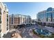 Aerial perspective of a city block with buildings and fountain at 4620 Piedmont Row Dr # 504, Charlotte, NC 28210