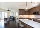 Open concept kitchen with island, stainless steel appliances, and dark wood cabinets at 4620 Piedmont Row Dr # 504, Charlotte, NC 28210