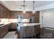 Modern kitchen with stainless steel appliances and large island at 4620 Piedmont Row Dr # 504, Charlotte, NC 28210