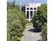 View of tree-lined street with city skyline in the distance at 4620 Piedmont Row Dr # 504, Charlotte, NC 28210