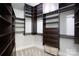 Large walk-in closet with ample shelving and drawers at 4620 Piedmont Row Dr # 504, Charlotte, NC 28210