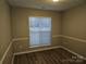 Simple bedroom with neutral walls and wood-look flooring at 4630 Sw Falcon Chase Sw Dr, Concord, NC 28027