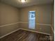 Bright bedroom with neutral walls and wood-look flooring at 4630 Sw Falcon Chase Sw Dr, Concord, NC 28027