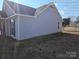 Side view of gray siding ranch home with mature trees at 4630 Sw Falcon Chase Sw Dr, Concord, NC 28027