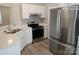 Modern kitchen with stainless steel appliances and white cabinets at 4630 Sw Falcon Chase Sw Dr, Concord, NC 28027