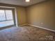 Bright bedroom with carpeted floor and large window at 4902 Spring Lake Dr # E, Charlotte, NC 28212