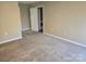 Spacious bedroom with carpeted floor and laundry access at 4902 Spring Lake Dr # E, Charlotte, NC 28212