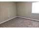 Carpeted bedroom with neutral walls at 4902 Spring Lake Dr # E, Charlotte, NC 28212