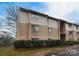 Brick condo building with landscaping and water view at 4902 Spring Lake Dr # E, Charlotte, NC 28212