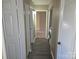 Long hallway with multiple doors and laundry access at 4902 Spring Lake Dr # E, Charlotte, NC 28212