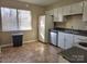 Galley kitchen with white cabinets and appliances at 4902 Spring Lake Dr # E, Charlotte, NC 28212