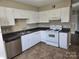 Kitchen with white cabinets and tiled floors at 4902 Spring Lake Dr # E, Charlotte, NC 28212