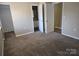 Main bedroom with carpet, closet and access to bathroom at 4902 Spring Lake Dr # E, Charlotte, NC 28212