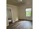 Simple bedroom with wood-look flooring and a window at 517 Ashford St, Chester, SC 29706