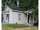 Simple white house with small front porch and yard at 517 Ashford St, Chester, SC 29706