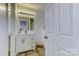 Clean bathroom, featuring a white vanity and a large mirror at 6411 Windsor Gate Ln, Charlotte, NC 28215