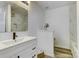 Modern bathroom with white vanity, marble tile, and a bathtub at 6411 Windsor Gate Ln, Charlotte, NC 28215