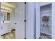 Bathroom with white vanity, linen closet, and marble shower at 6411 Windsor Gate Ln, Charlotte, NC 28215