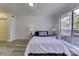 Well-lit bedroom with vinyl flooring and large window at 6411 Windsor Gate Ln, Charlotte, NC 28215