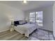 Bedroom with gray carpet, featuring a large window and ample natural light at 6411 Windsor Gate Ln, Charlotte, NC 28215