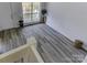 Bright entryway with vinyl flooring, featuring a view to the backyard at 6411 Windsor Gate Ln, Charlotte, NC 28215