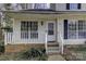 Front view of townhome with white porch and stairs at 6411 Windsor Gate Ln, Charlotte, NC 28215