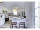 Modern kitchen with white cabinets, island, and stainless steel appliances at 6411 Windsor Gate Ln, Charlotte, NC 28215