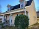 Tan colored siding, covered porch, and landscaping at 8024 Bronze Pike Dr, Charlotte, NC 28273