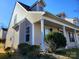 Tan colored siding, covered porch, and landscaping at 8024 Bronze Pike Dr, Charlotte, NC 28273